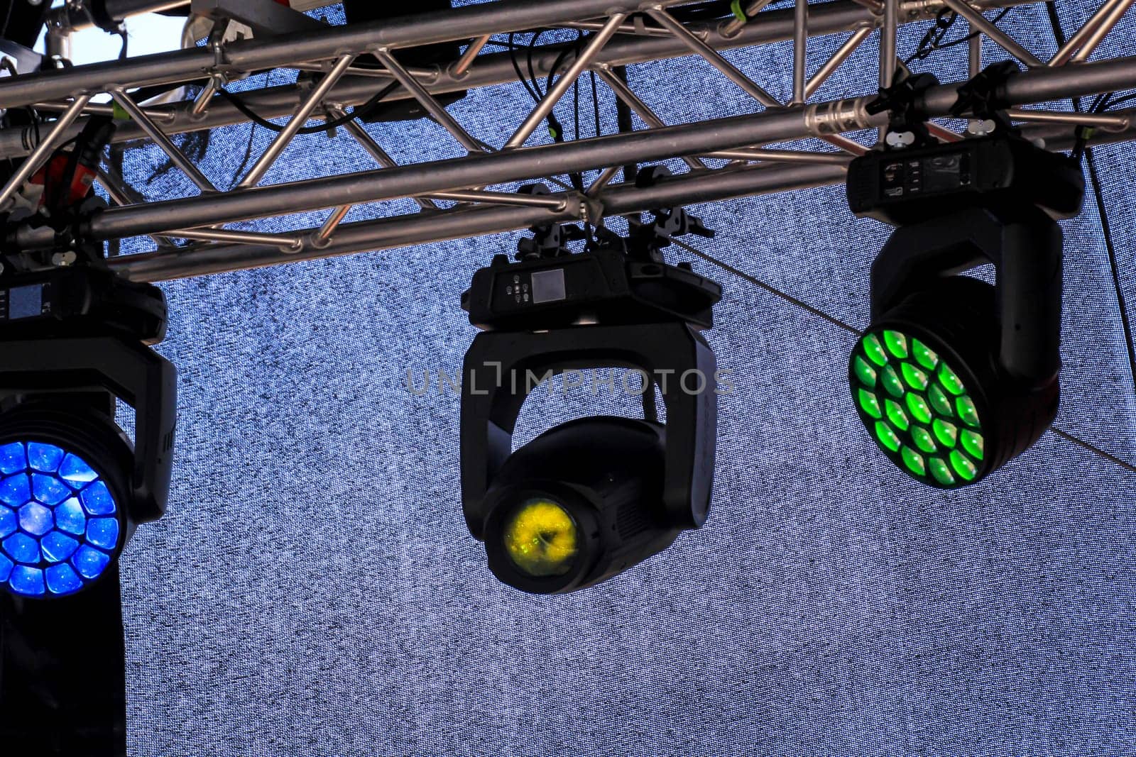 Spotlights for the illumination of a stage hang on a mounting scaffold.