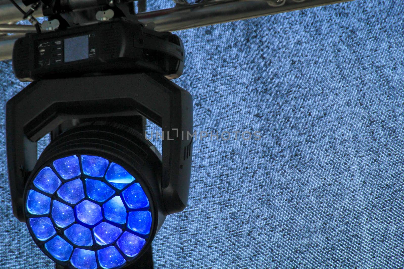 Spotlights for the illumination of a stage hang on a mounting scaffold.