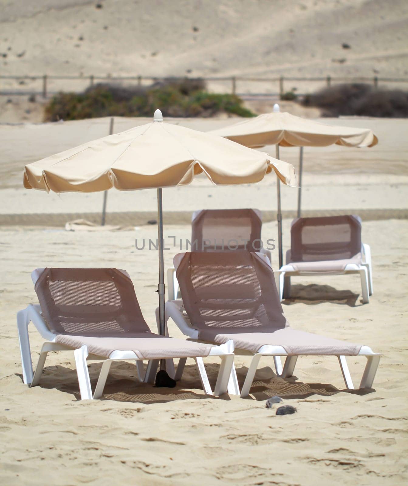 Several sunbeds and umbrellas are available on the beach for sun-seekers.