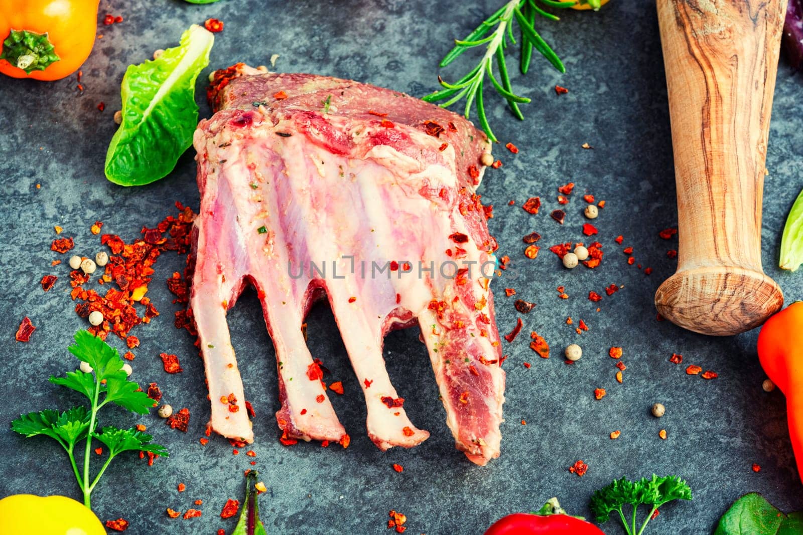 Appetizing raw lamb rib and spices on the kitchen table.