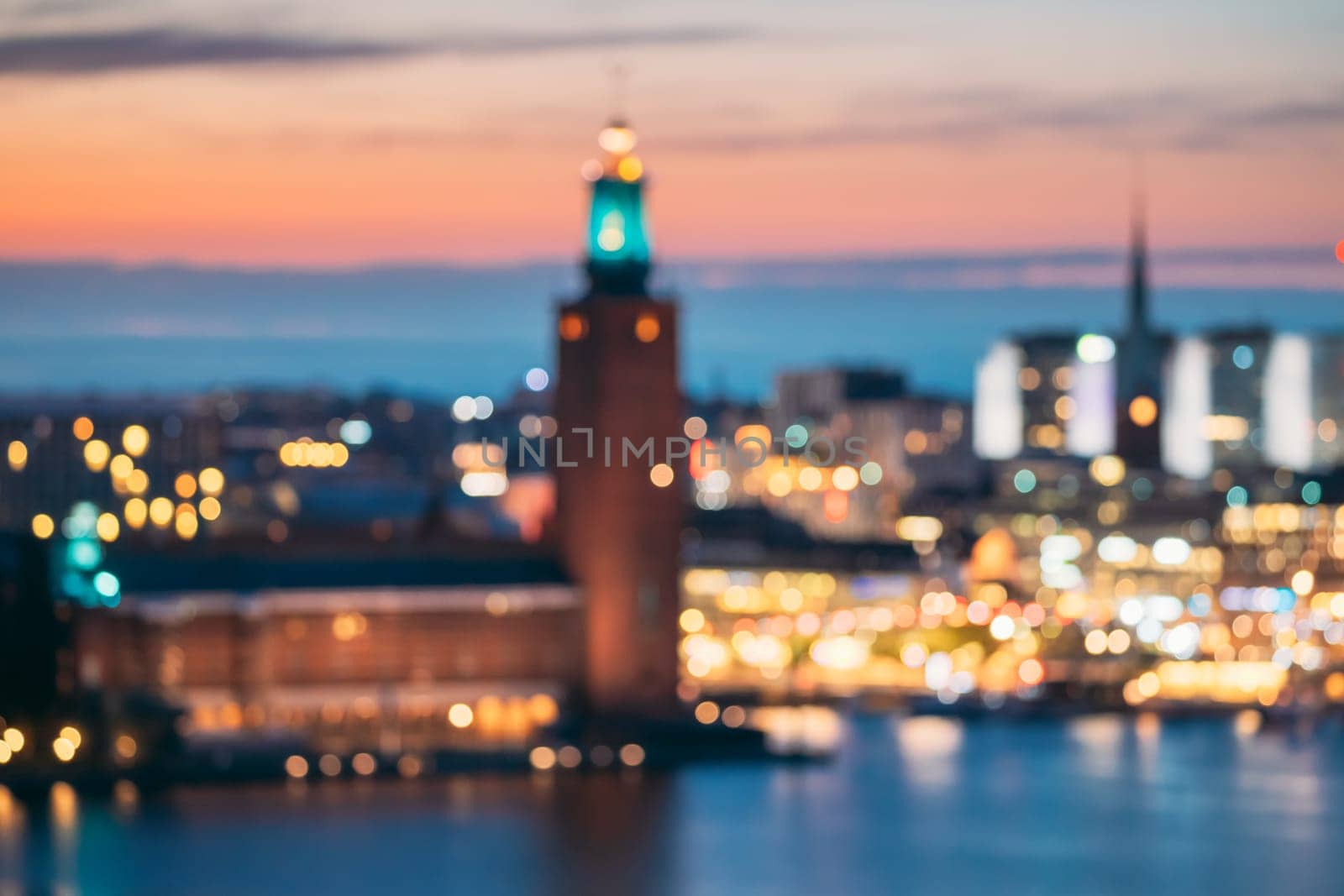 Stockholm, Sweden. Night Skyline Abstract Boke Bokeh Background. Design Backdrop. Tower Of Stockholm City Hall.