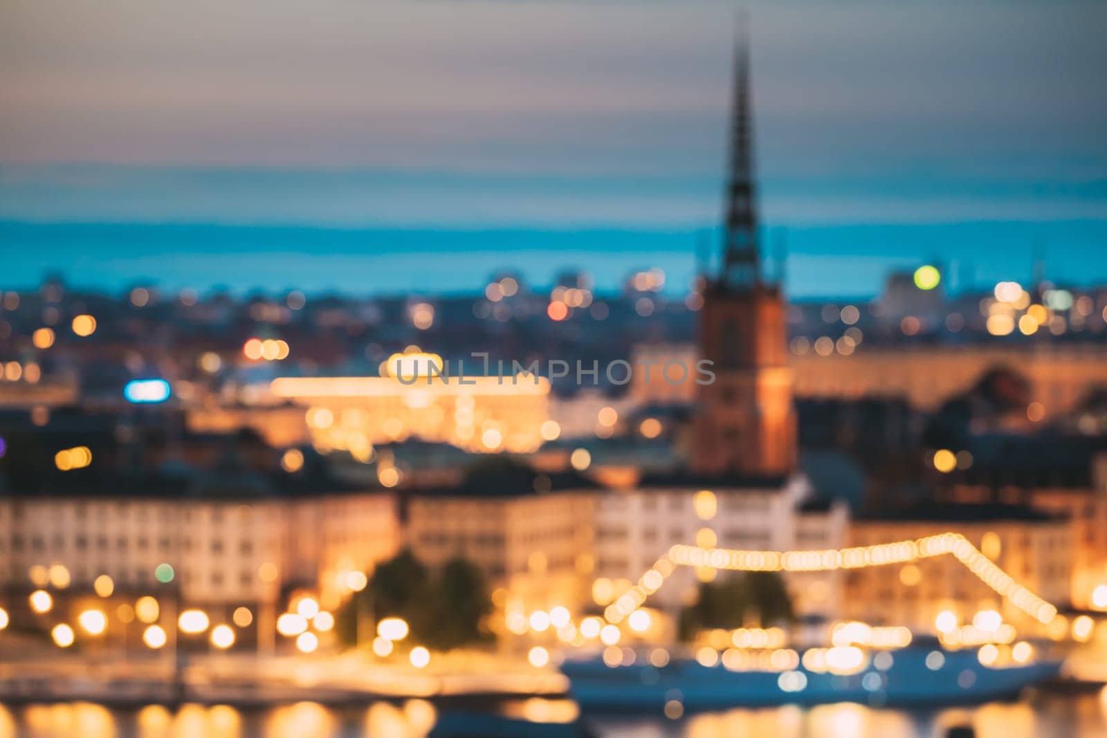 Stockholm, Sweden. Night Skyline Abstract Boke Bokeh Background. Design Backdrop. Riddarholm Church In Night Lighting