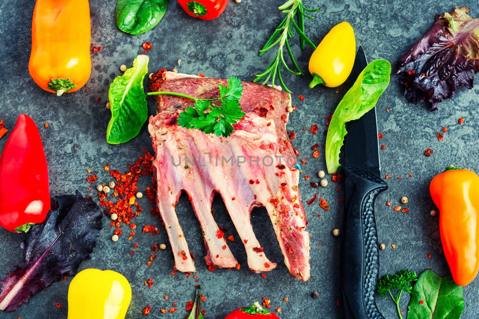 Appetizing raw lamb rib and spices on the kitchen table.