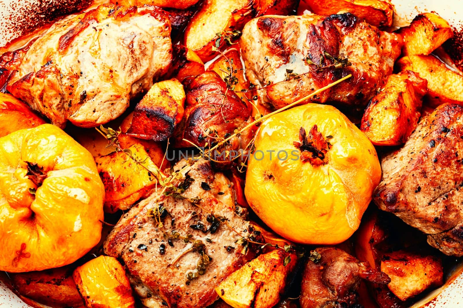 Delicious meat cooked with autumn fruits on the plate