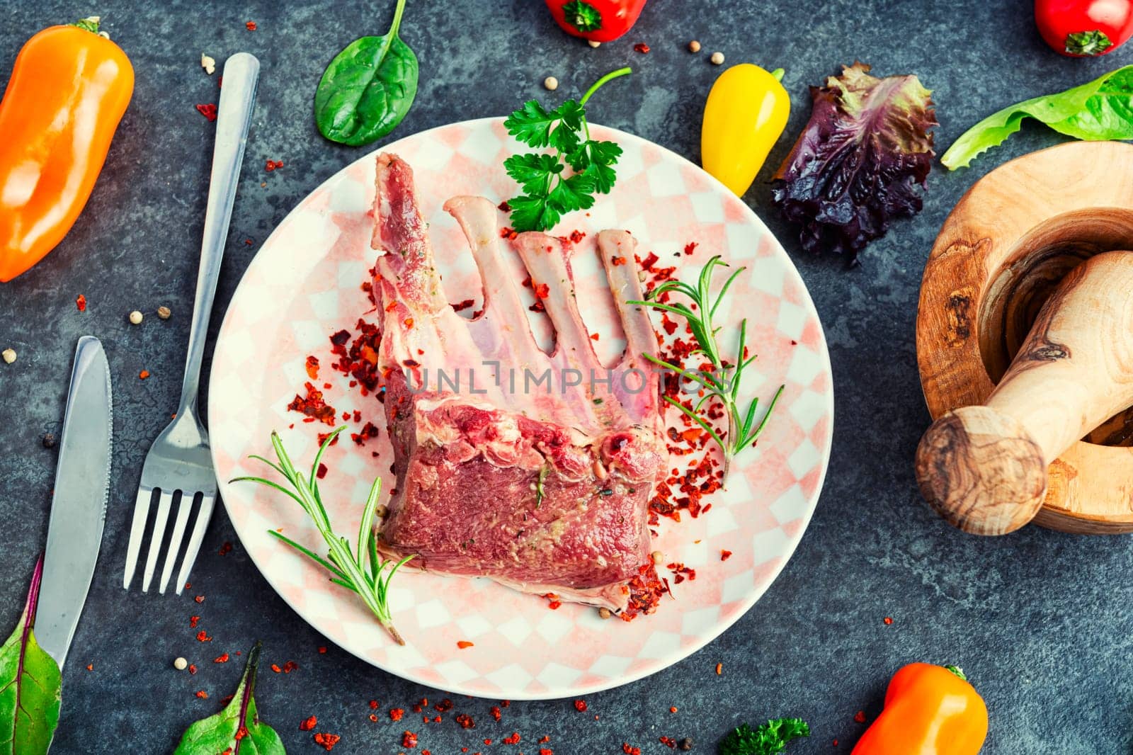 Appetizing raw lamb rib and spices on the kitchen table.