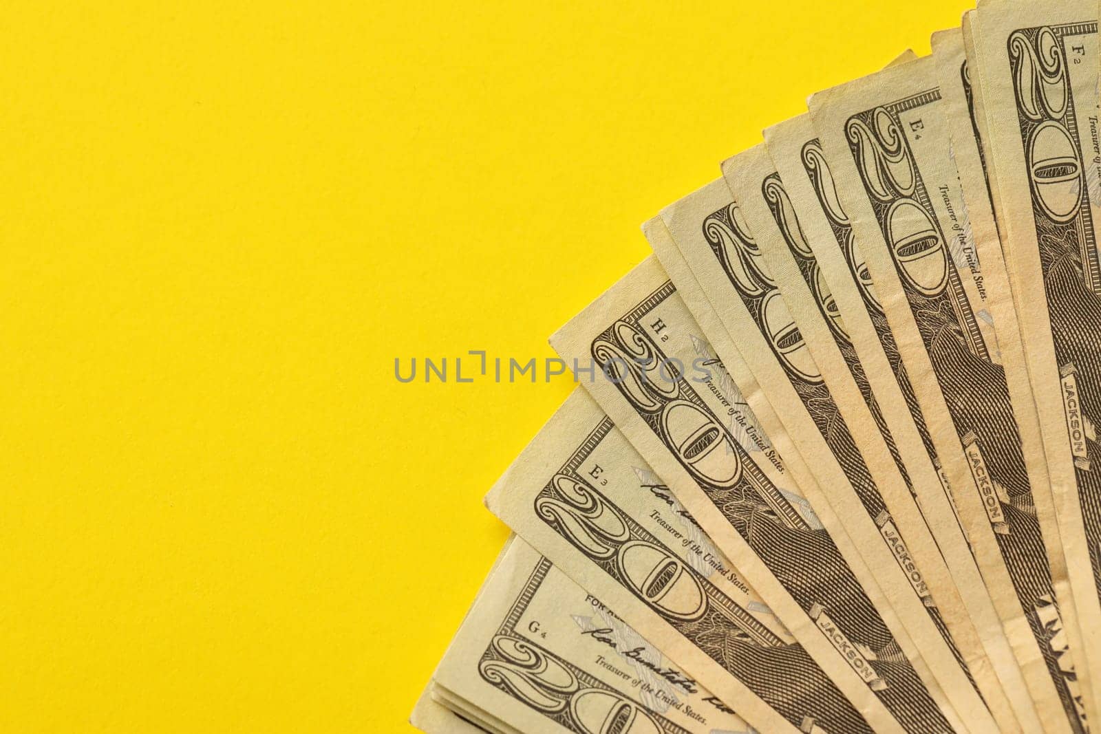 Big amount of old twenty dollar bills on yellow background. Money earnings, payday or tax paying period concept