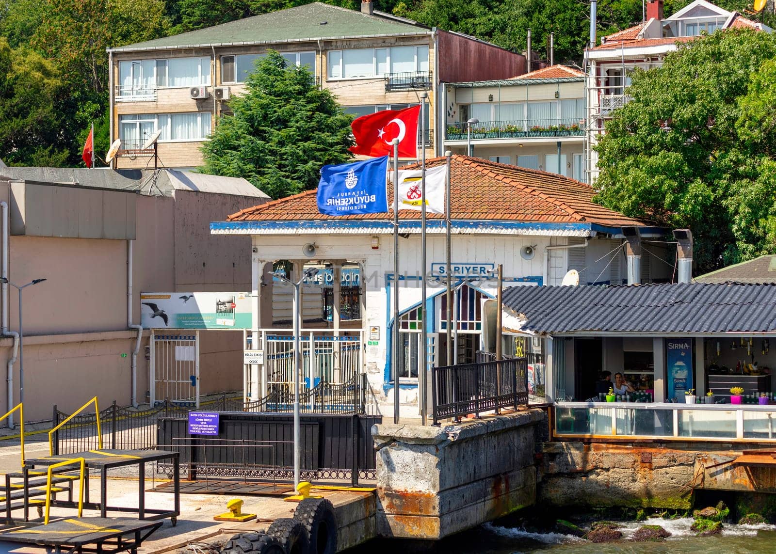 Istanbul, Turkey - August 29, 2022: Bosphorus Strait, Sariyer Ferry Terminal with dense green trees in the background