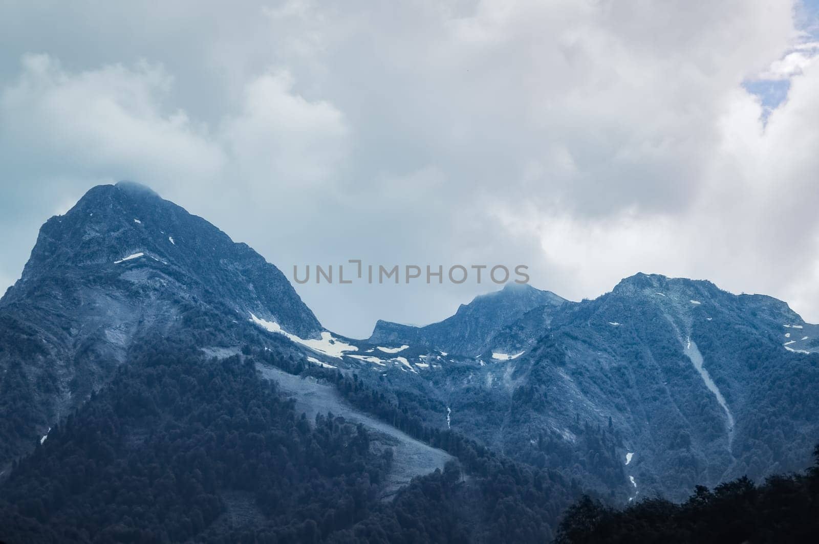 Mountain landscape. Snowy peak. Fog and aerial perspective