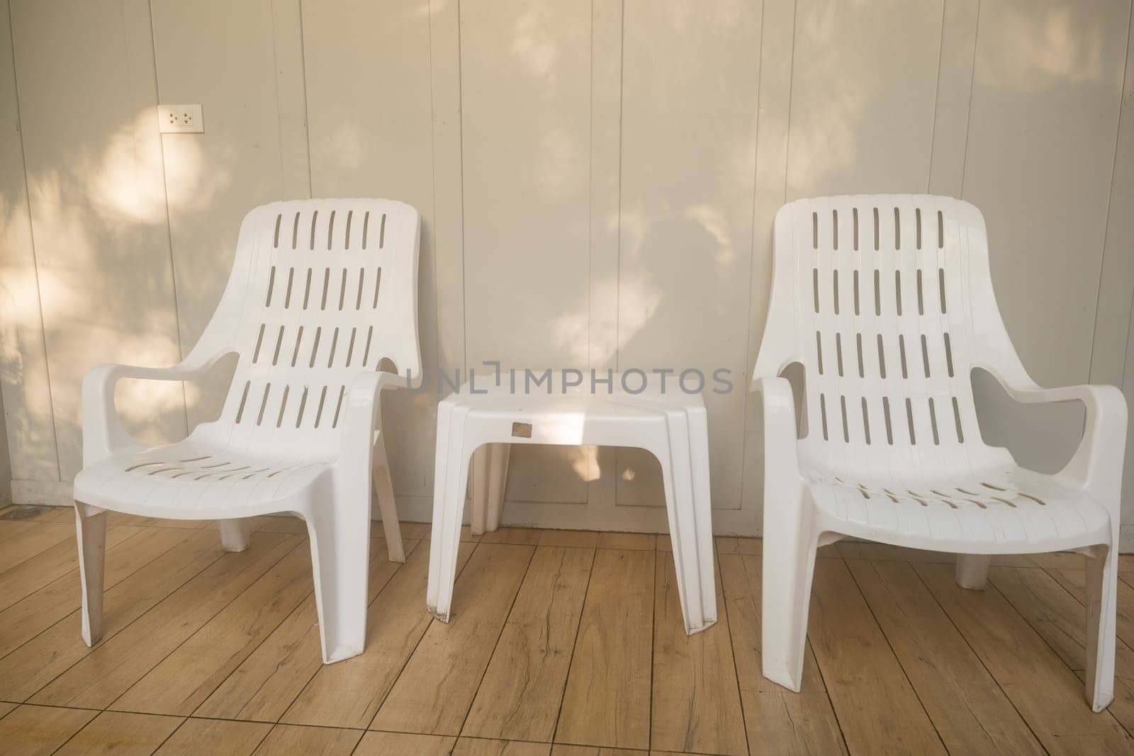 Nobody white chair around outdoor swimming pool in resort hotel empty behind the room for leisure travel vacation