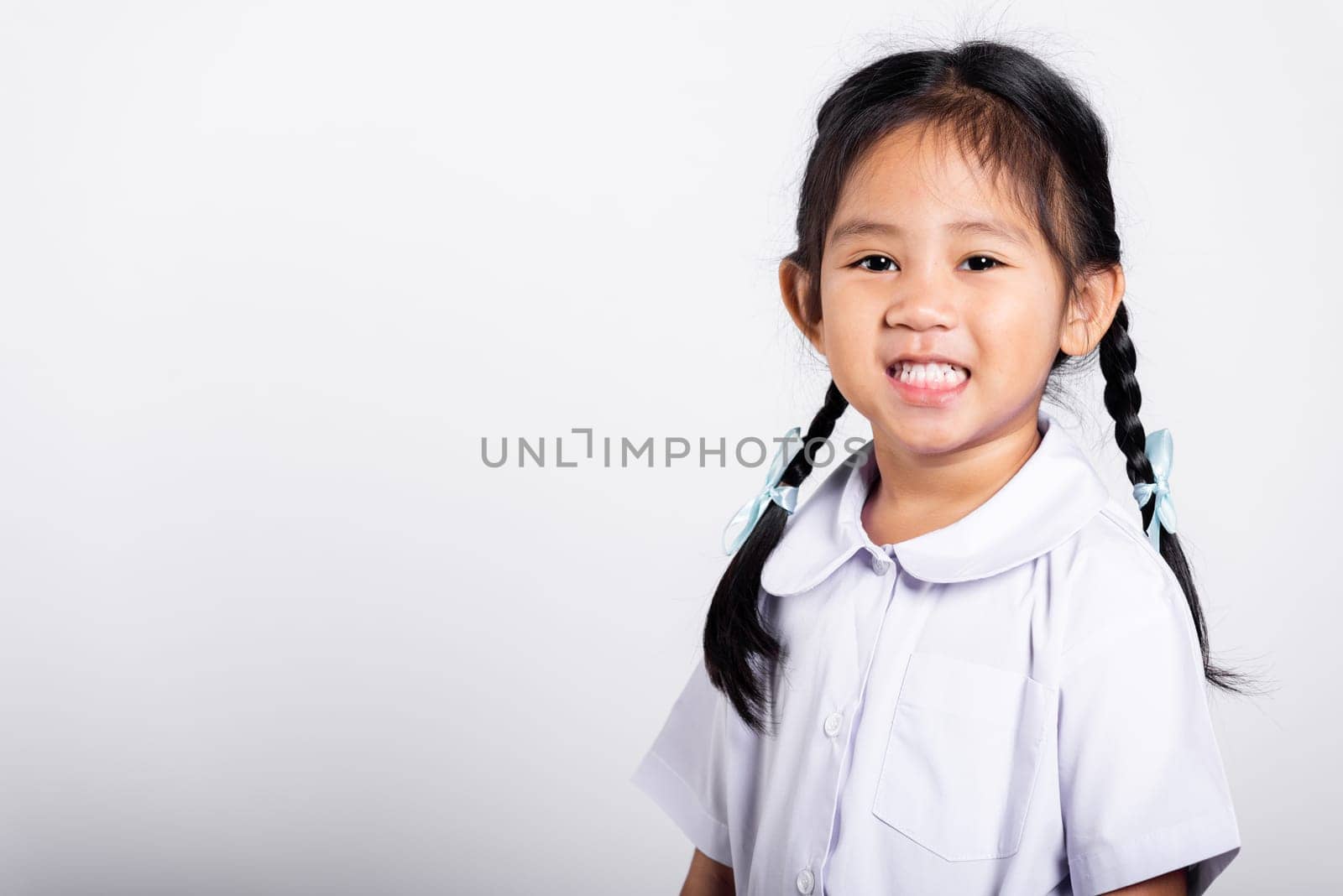 Asian adorable toddler smiling happy wearing student thai uniform red skirt standing in studio shot isolated on white background, Portrait little children girl preschool, Happy child Back to school