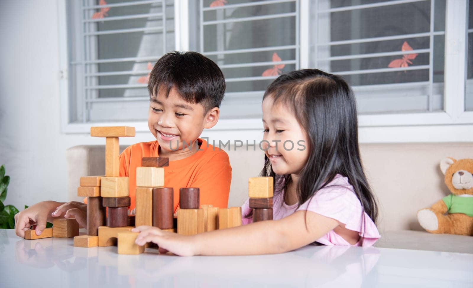 Happy little kids play wood block stacking board game at home, Children boy and girl playing with constructor wooden block, childhood activities learning creative, toys for preschool and kindergarten