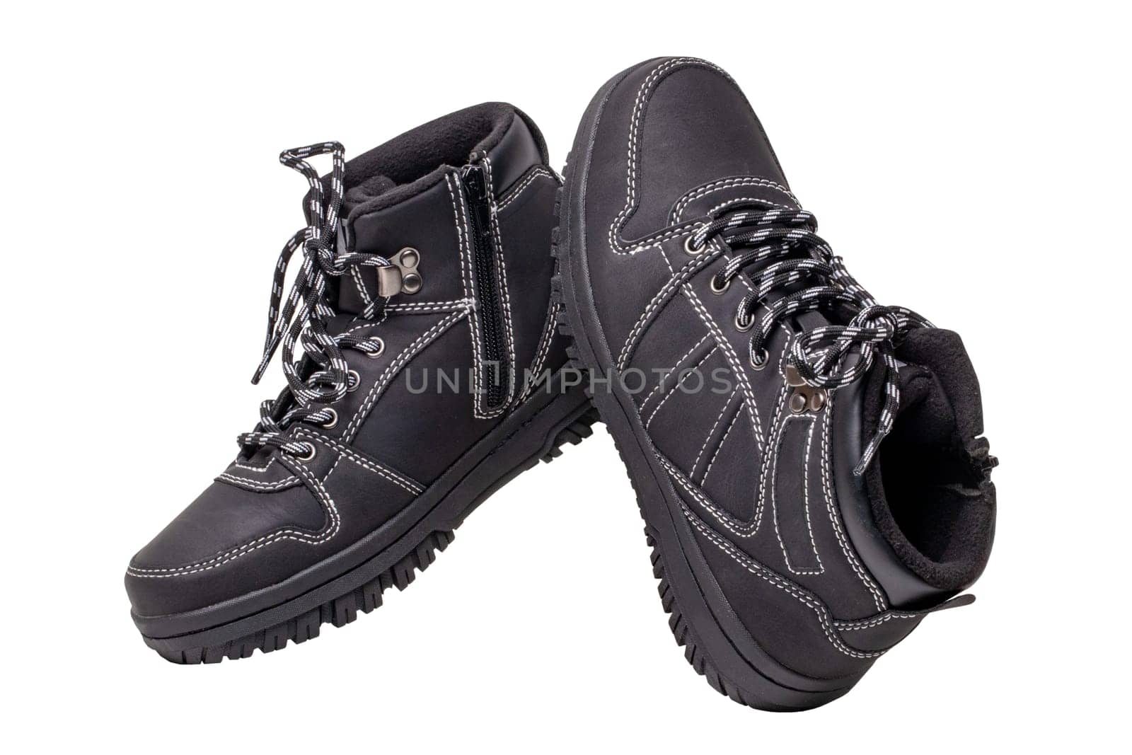 Winter boots. Close-up of a pair elegant black leather winter boots with laces and rivets isolated on white. Clipping path. Macro. Autumn shoe fashion for child boy.