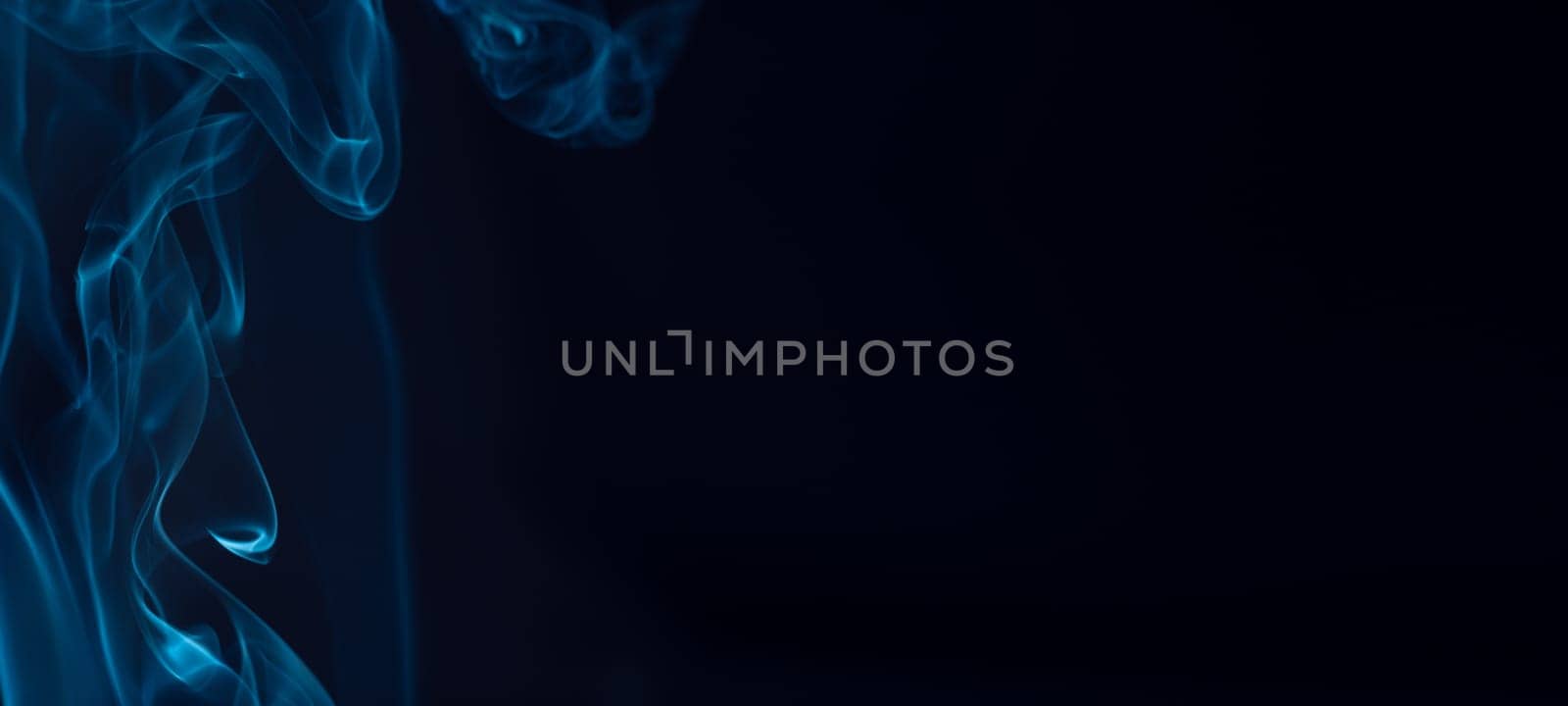 Creative background partially blurred image, horizontal dark blue banner with puffs of neon blue white smoke. Copy space. Place for text