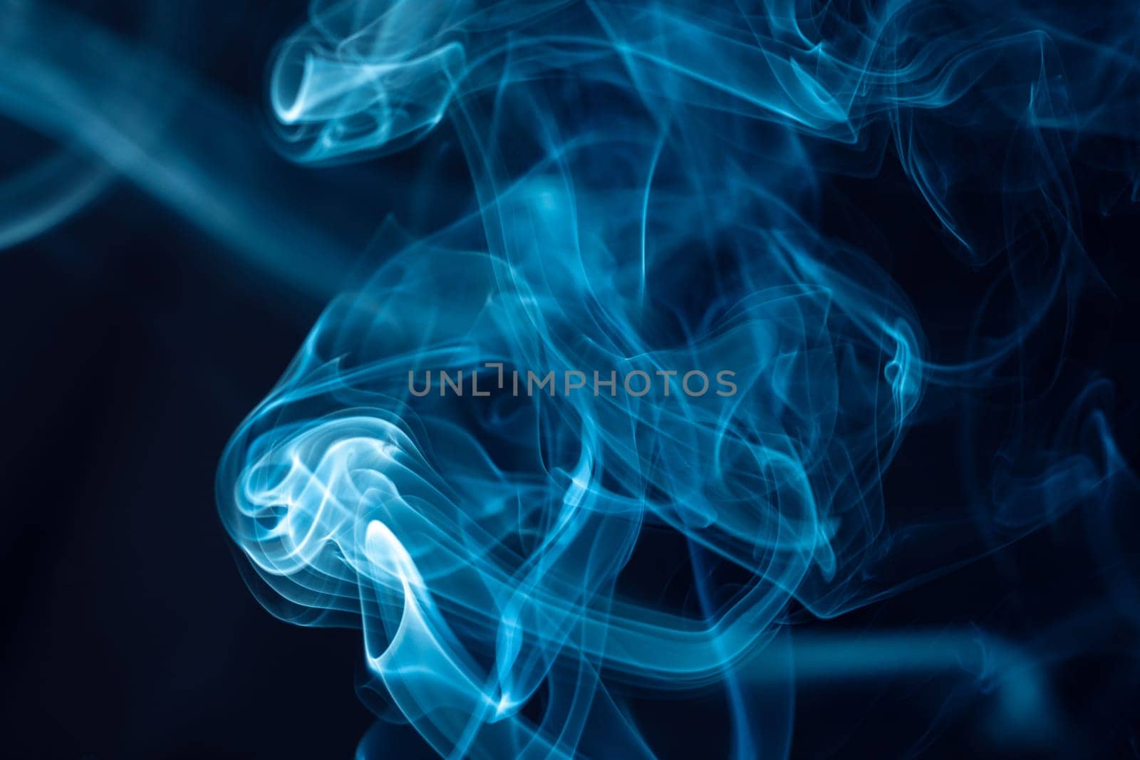 Creative background partially blurred image, horizontal dark blue backdrop with puffs of neon blue white smoke. Copy space. Place for text
