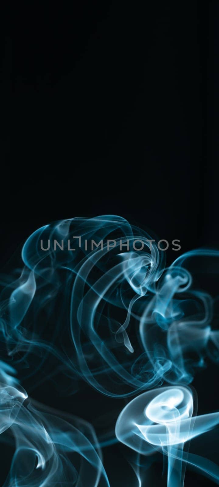 Creative background partially blurred image, vertical dark blue banner with puffs of neon blue white smoke. Copy space. Place for text