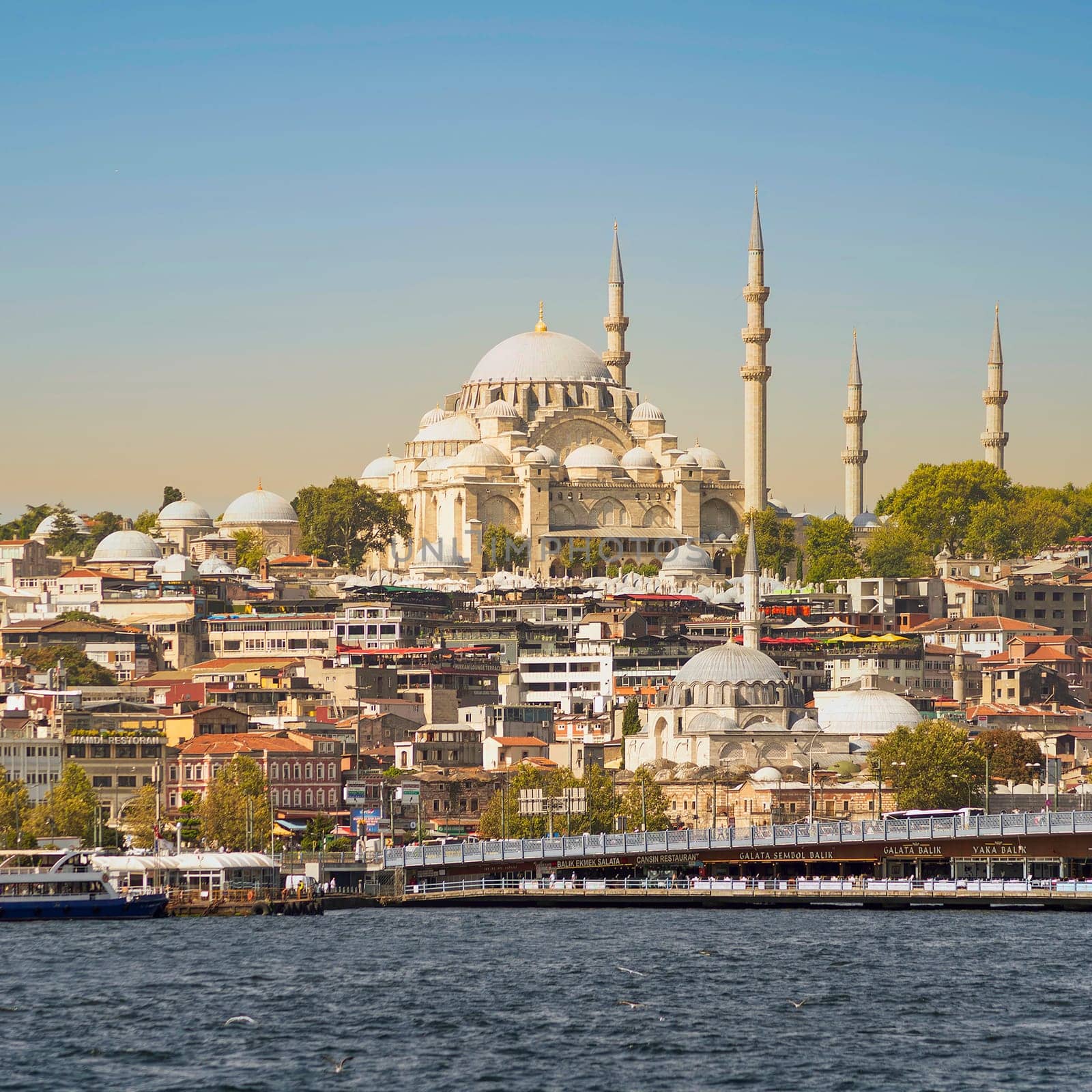 Istanbul, Turkey - August 29, 2022: Istanbul city view from Karakoy overlooking Golden Horn with Galata Bridge, and Suleymaniye Mosque, in a summer day