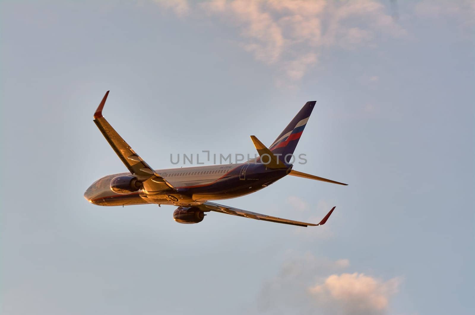 The Boeing plane flies against the background of a blue sky with clouds. Talagi Airport, Arkhangelsk, Russia, 27,08,2022. High quality photo