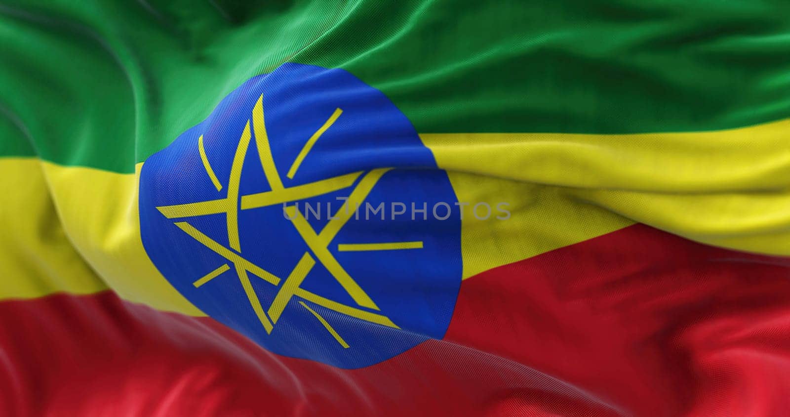 Close-up view of the Ethiopia national flag waving in the wind. The Federal Democratic Republic of Ethiopia is a state located in the Horn of Africa. Fabric textured background. Selective focus