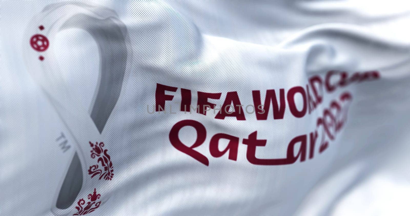 Doha, QA, October 2022. Close-up view of the FIFA Qatar 2022 World Cup flag waving in the wind. The World Cup will take place in Qatar from 20 November to 18 December 2022