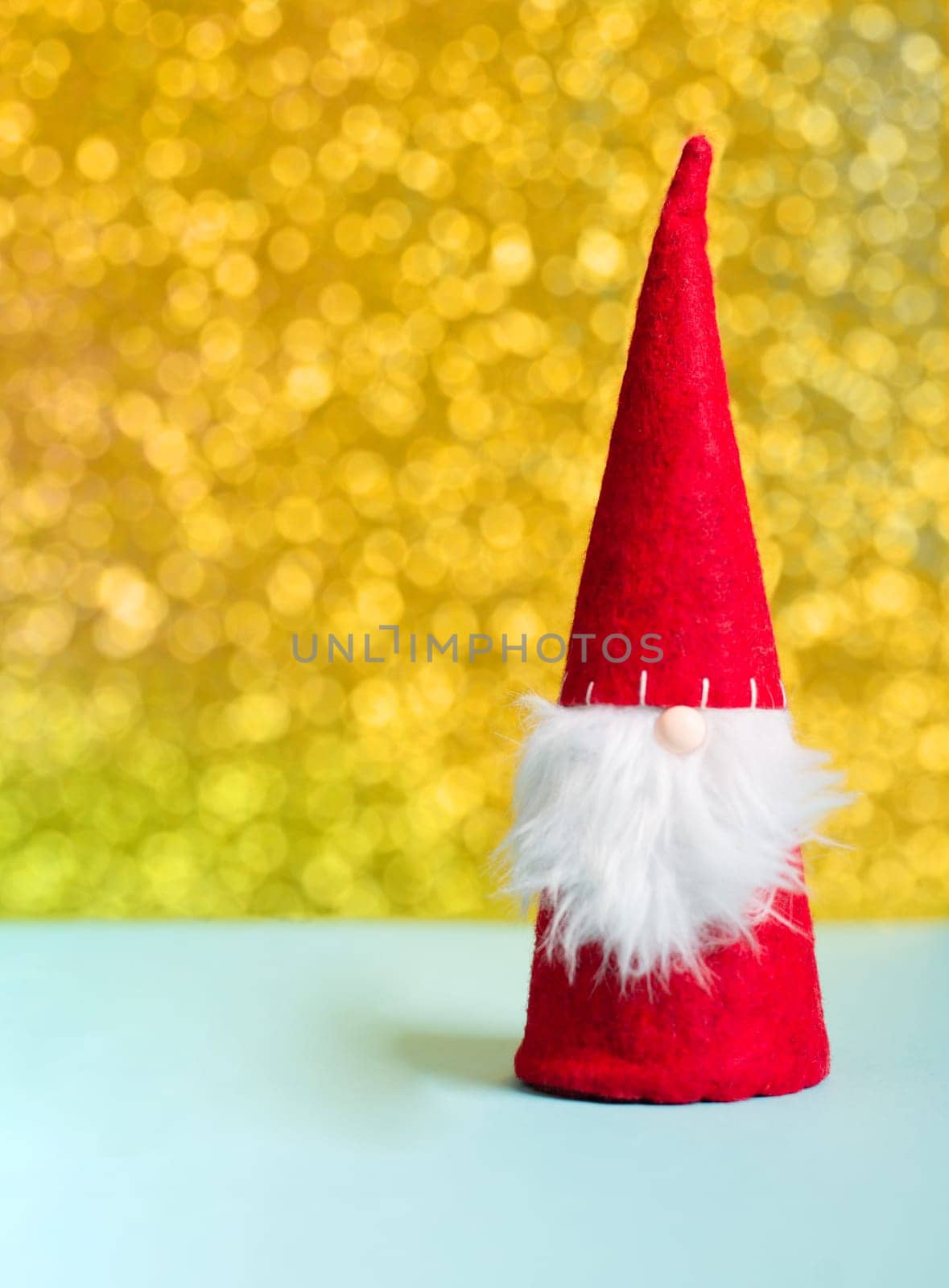 Gnome with golden bokeh fairy lights, christmas holiday greeting card, winter season