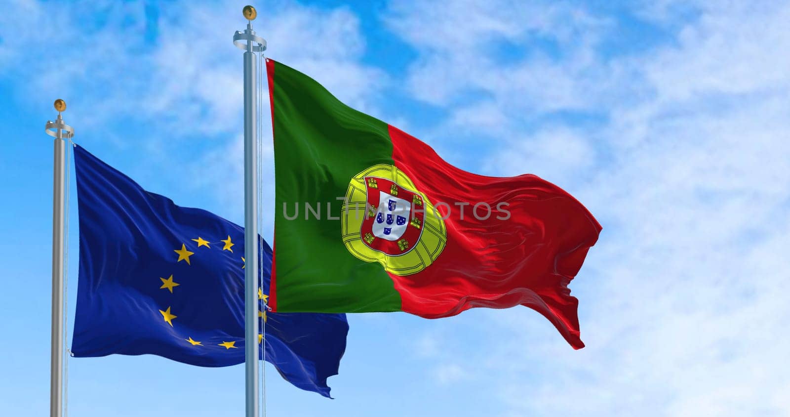 The national flag of Portugal waving in the wind with the european union flag on a clear day. Democracy and politics. European country. Selective focus.