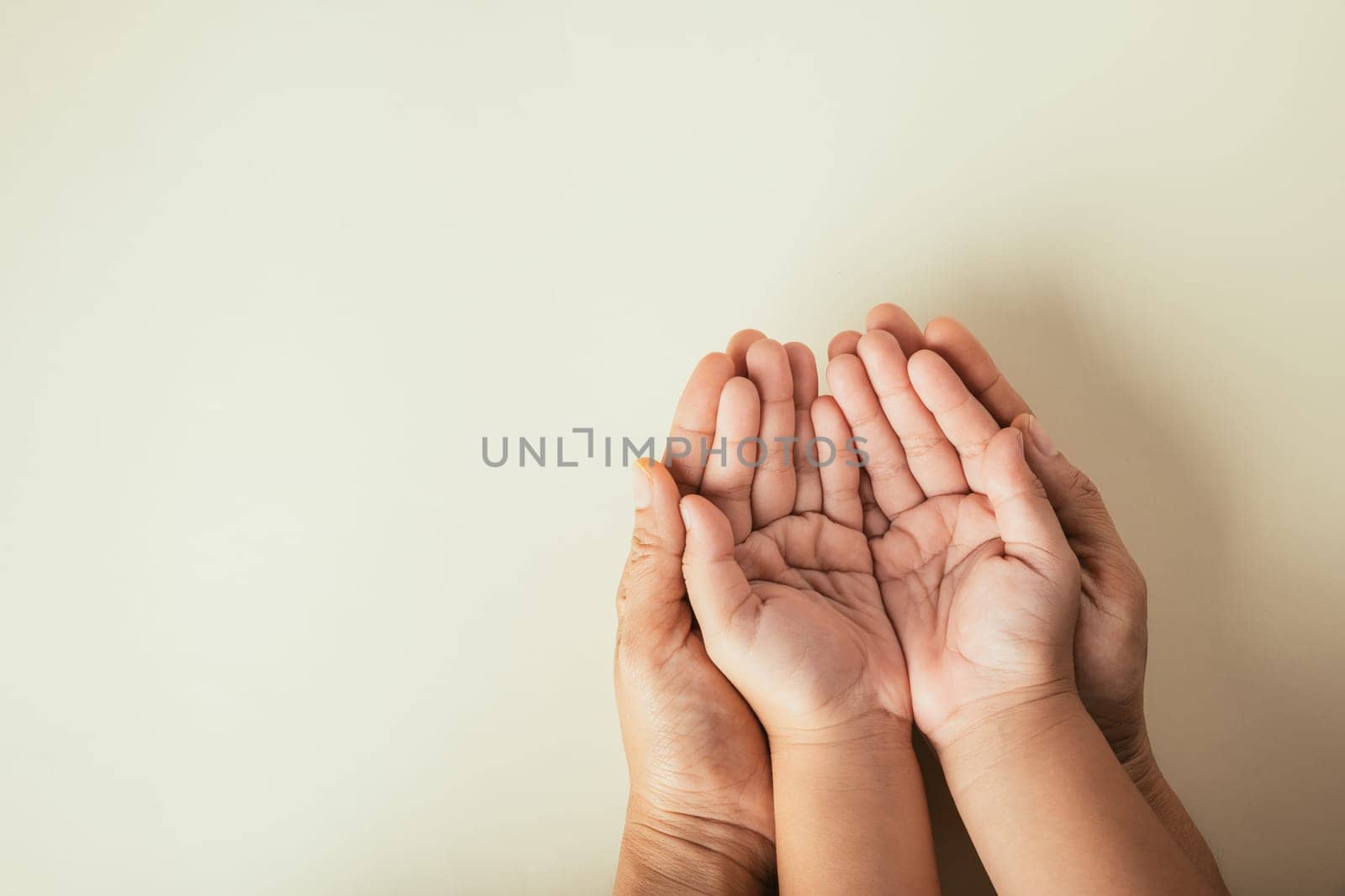 Close up hands children on adult mother hand, Top view person kid stack mom palms, Parents and little kid holding empty hands together isolated on pastel background, Family day care concept