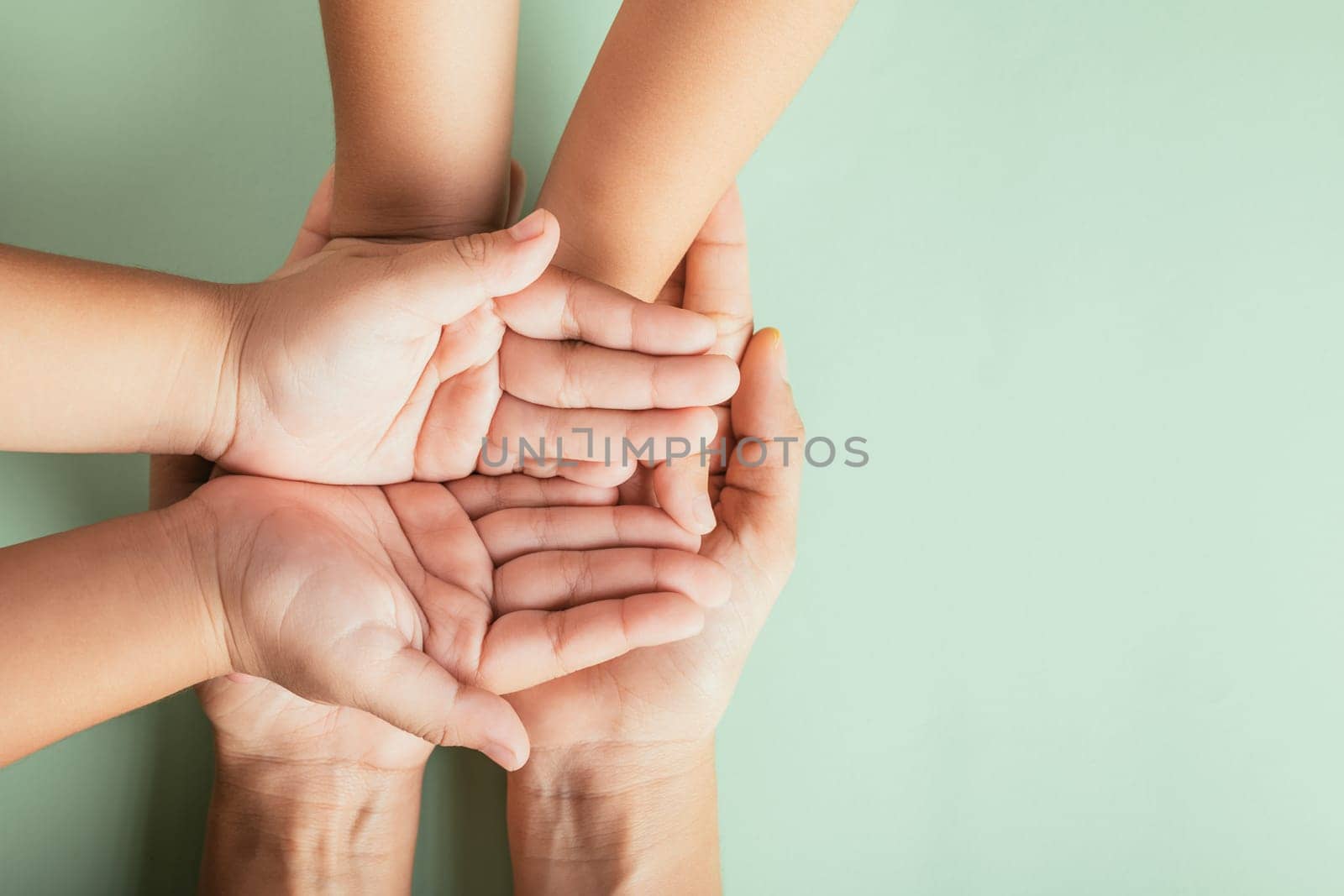 Close up hands children on adult mother hand, Top view person kid stack mom palms, Parents and little kid holding empty hands together isolated on green background, Family day care concept
