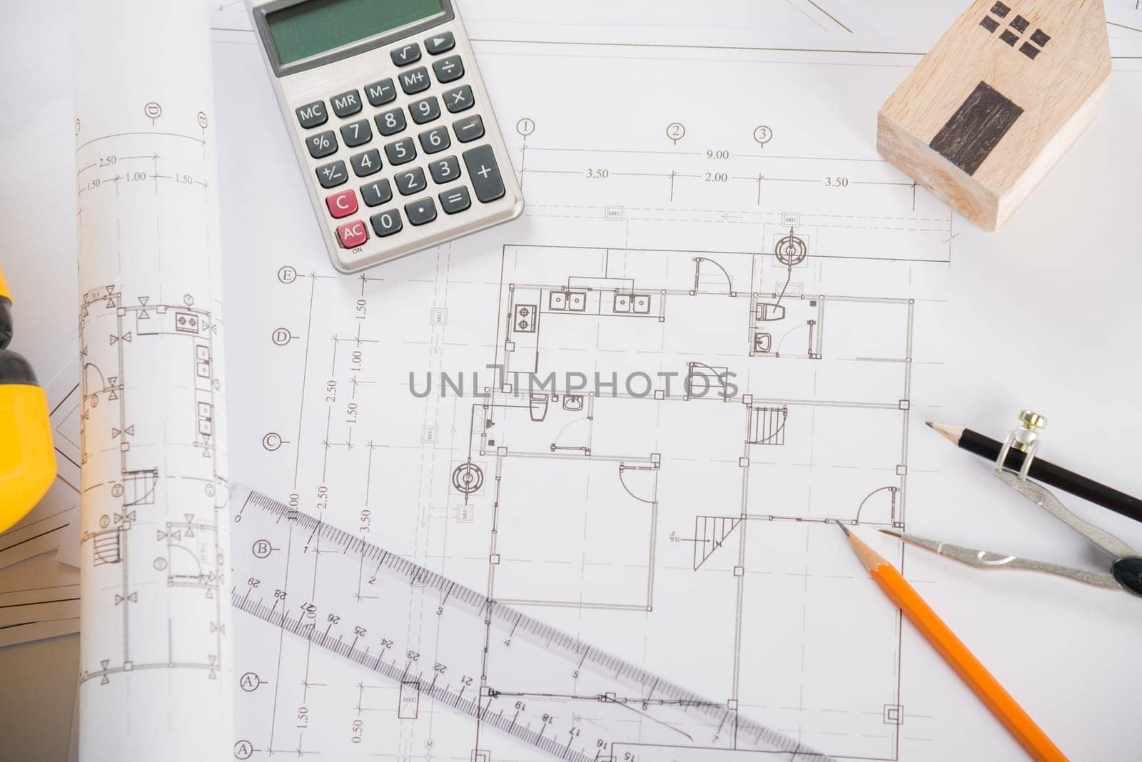 Architectural project workplace. Top view of house plan blueprint paper with repair tools on table desk at architecture office, Engineering architect design tools concept