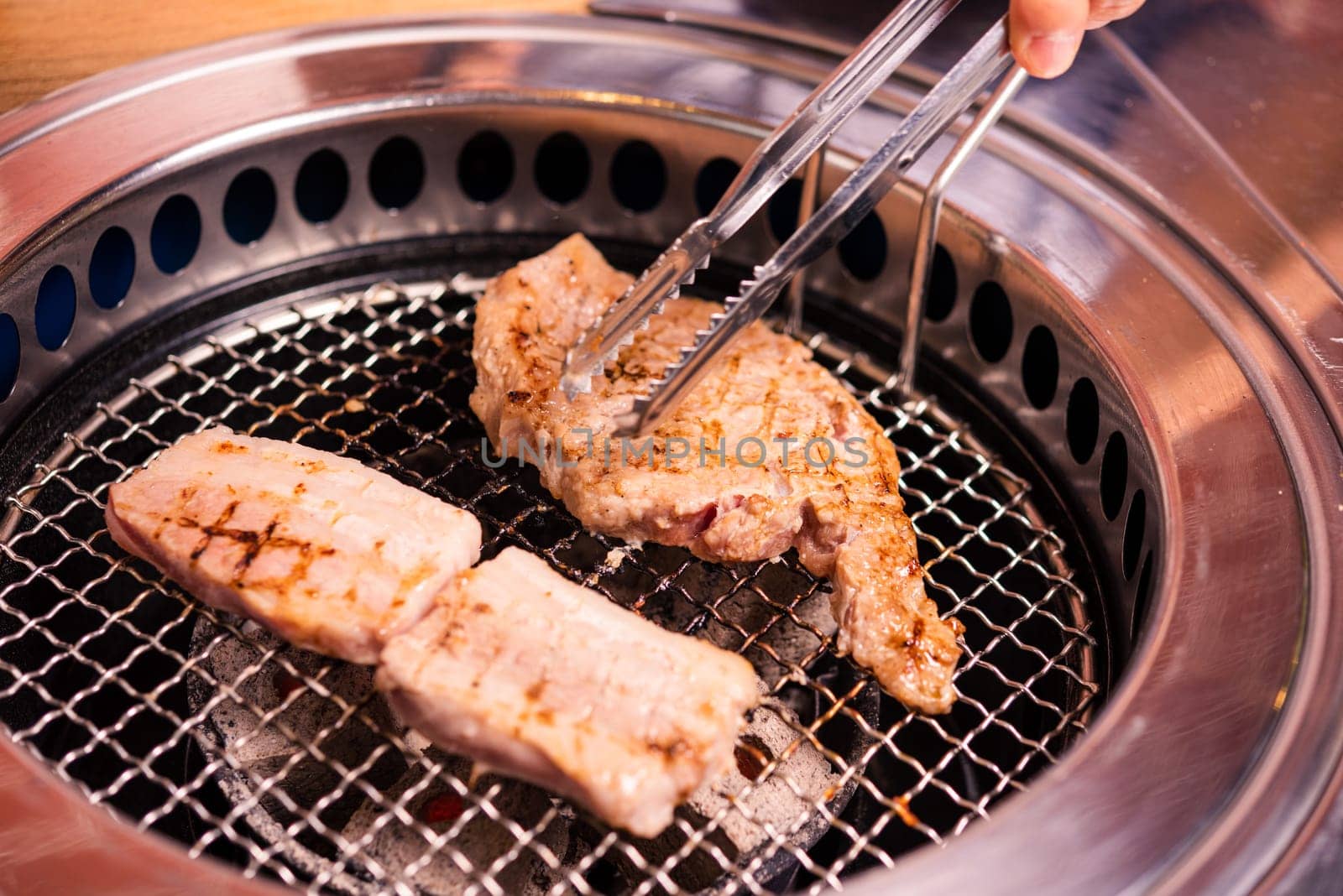 Korean beef barbecue on hot coals. Grill meat pork Korean BBQ traditional style on stove serve in restaurant, Japanese food