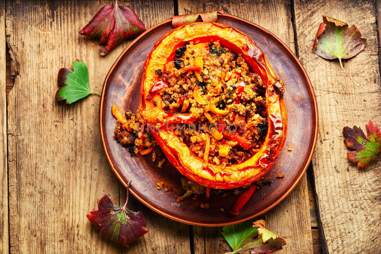 Vegetarian food, pumpkin baked with vegetables on the plate.