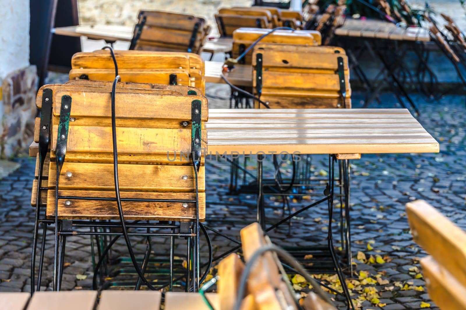 Fastened seats and tables in a front of a restaurant