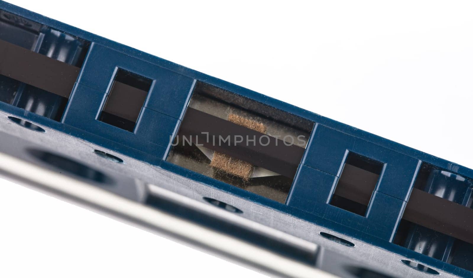 Cassette music tape in detail from above isolated over white background