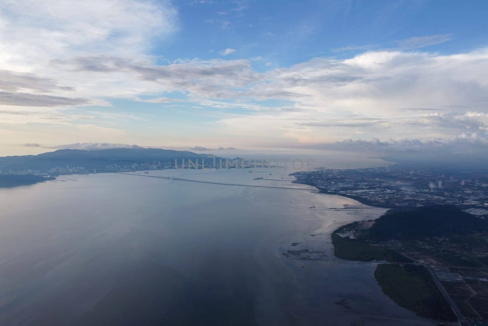 Aerial view Penang Bridge connect mainland and island in blue cloud day