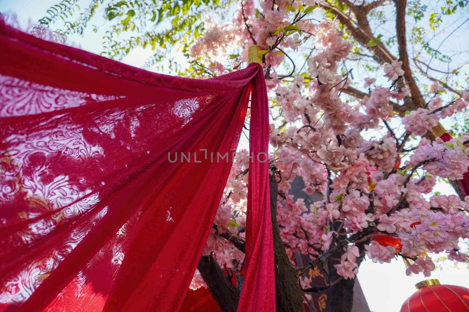 Chinese new year decoration red fabric with artificial plum blossom outdoor