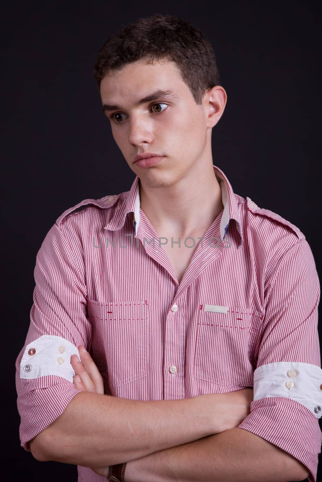 young casual man against a black background