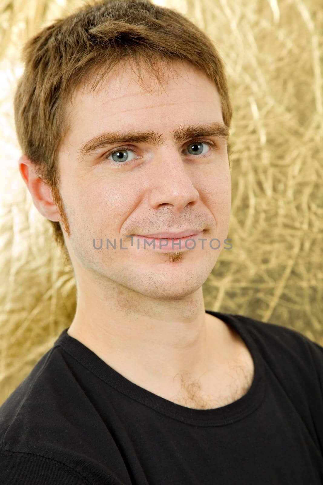 young casual man against a golden background