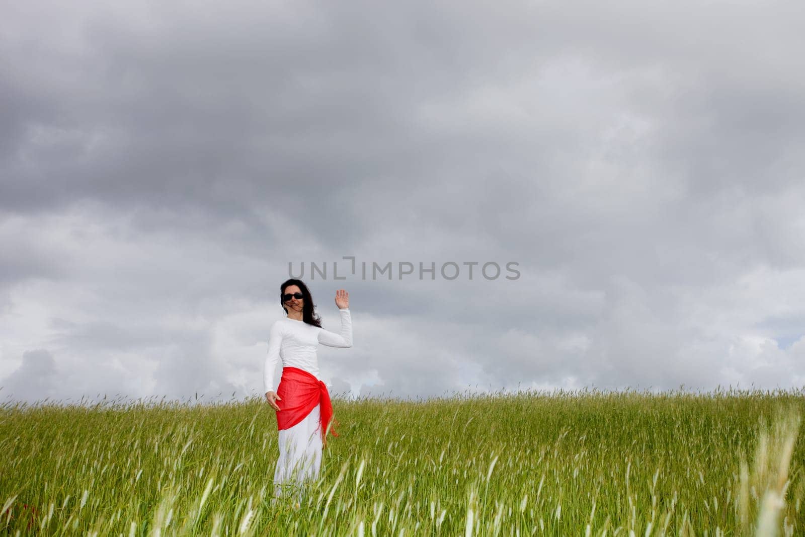 beautiful young woman on field with a red scarf