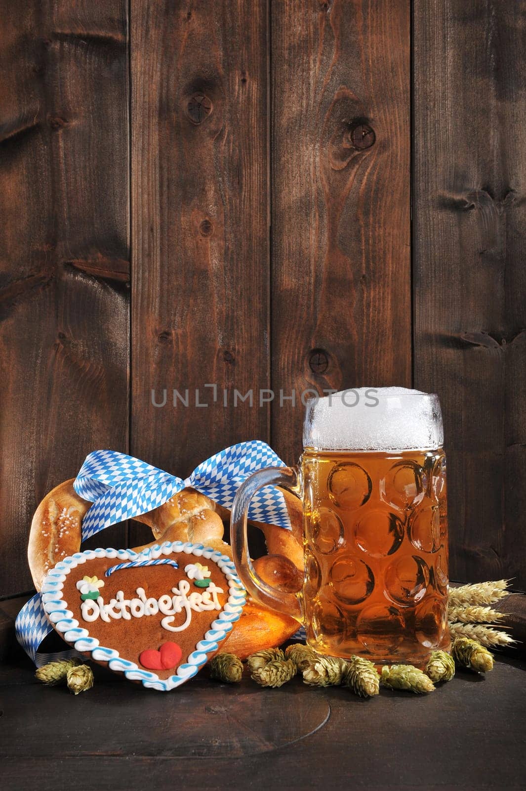original Bavarian XXL Oktoberfestbreze with beer mug,hops and gingerbread heart on old beer barrel