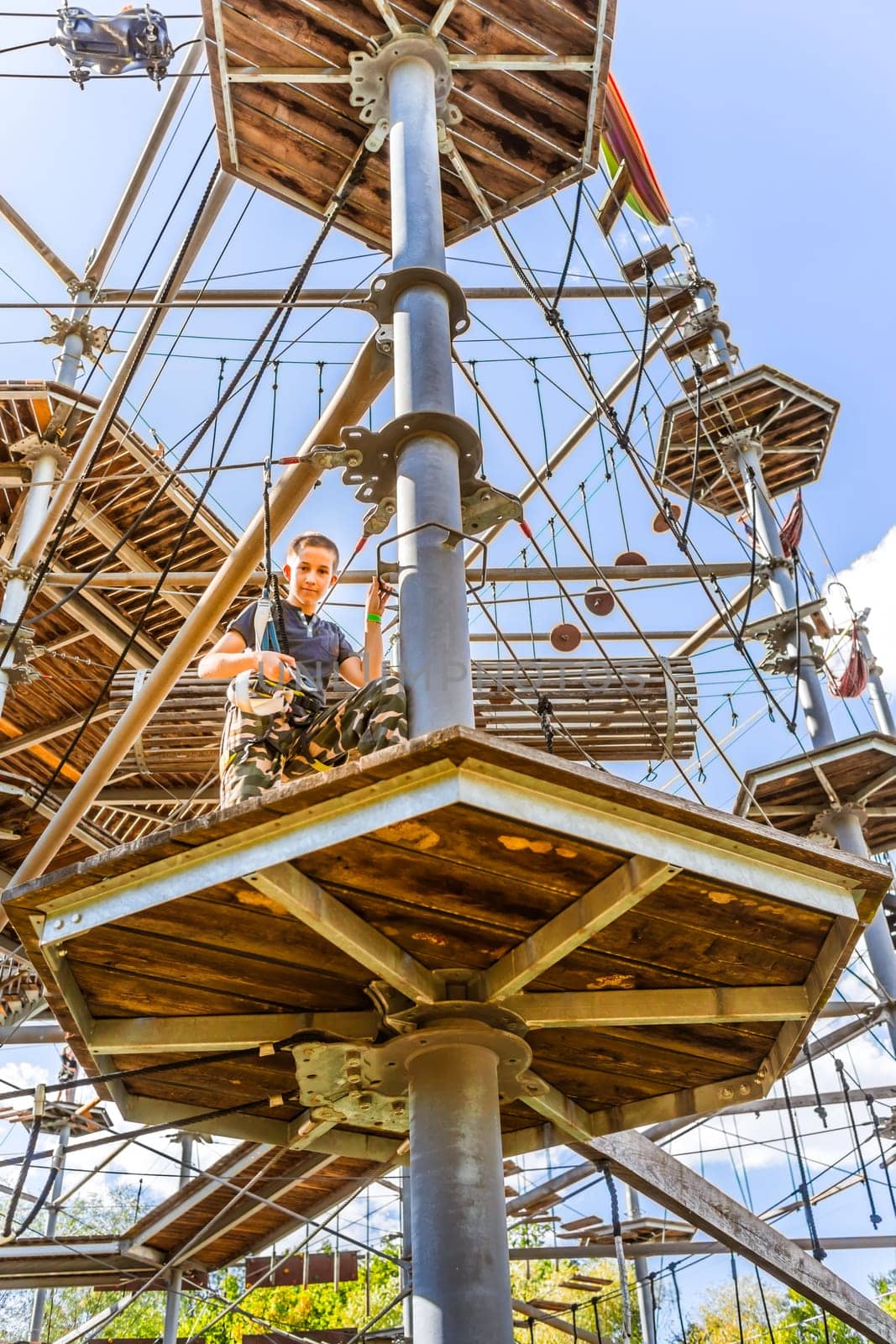Child climbing in the high ropes course. Sport and adventure concept.