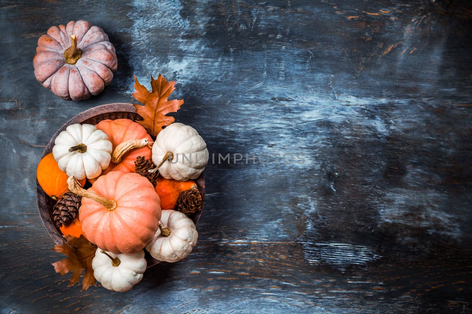Thanksgiving and Halloween concept. Pumpkins and autumn leaves.