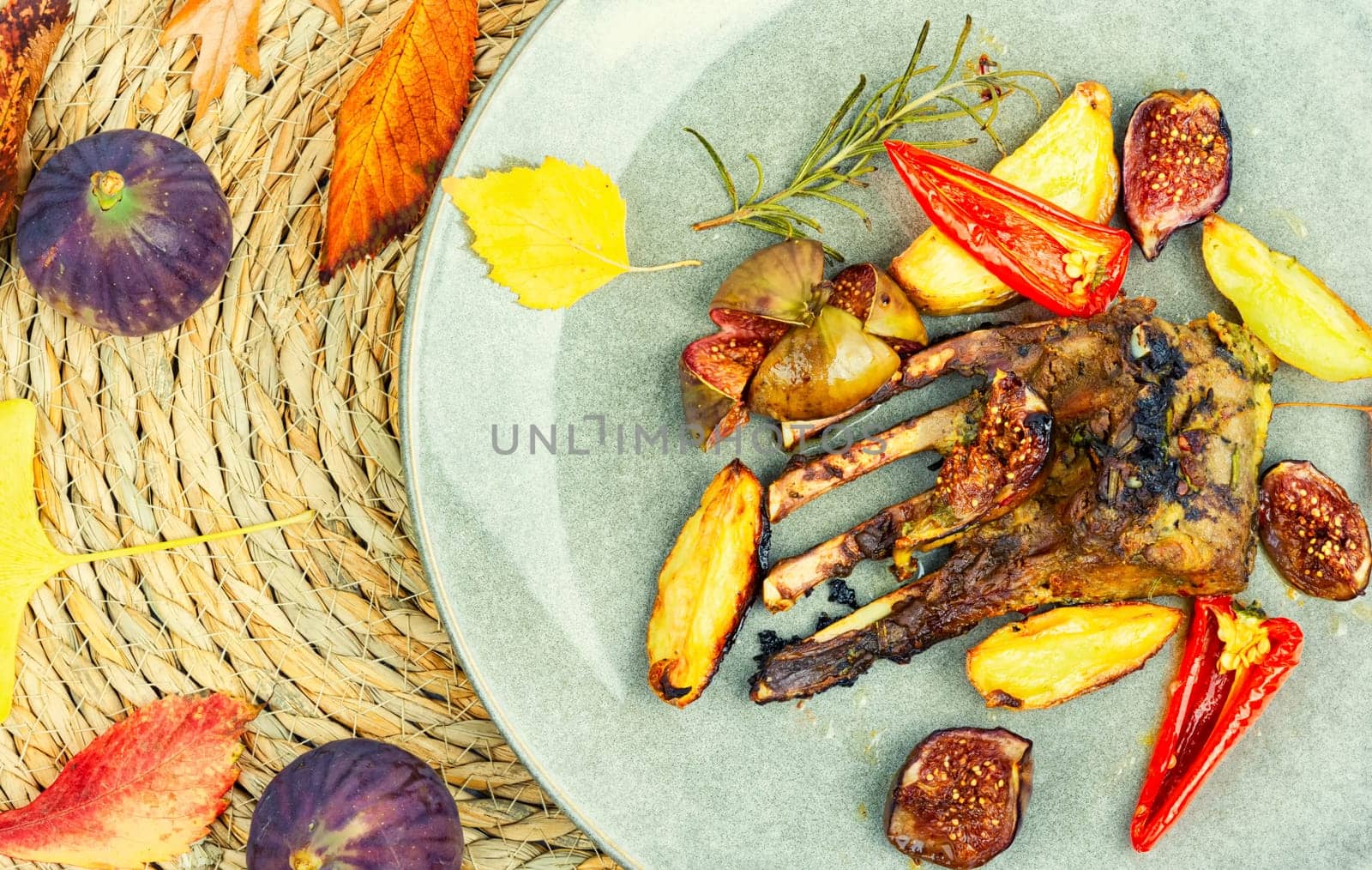 Lamb meat on the ribs, roasted with figs. Rack of lamb