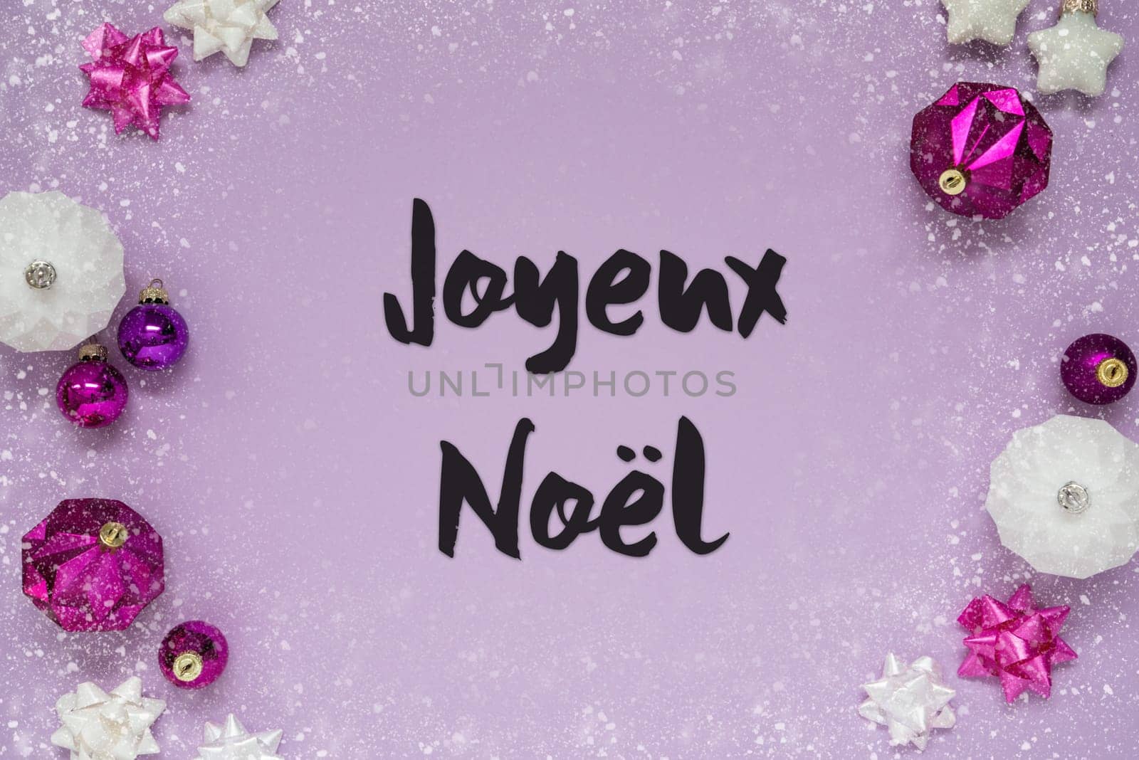 Christmas Card With French Text Joyeux Noel Means Merry Christmas. Purple Christmas Background With Romantic And Brilliant Decoration Like Balls And Snowflakes