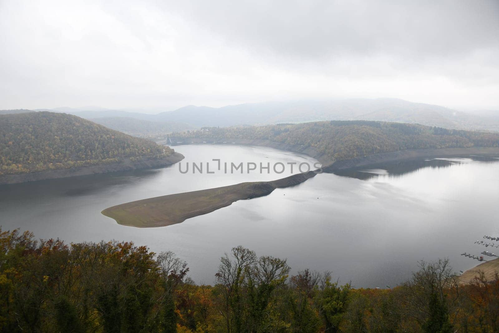 The Edertalsee in autumn with clouds. The reservoir is located in Germany in the state of Hesse. The Edertalsperre was built to keep the river Weser navigable.