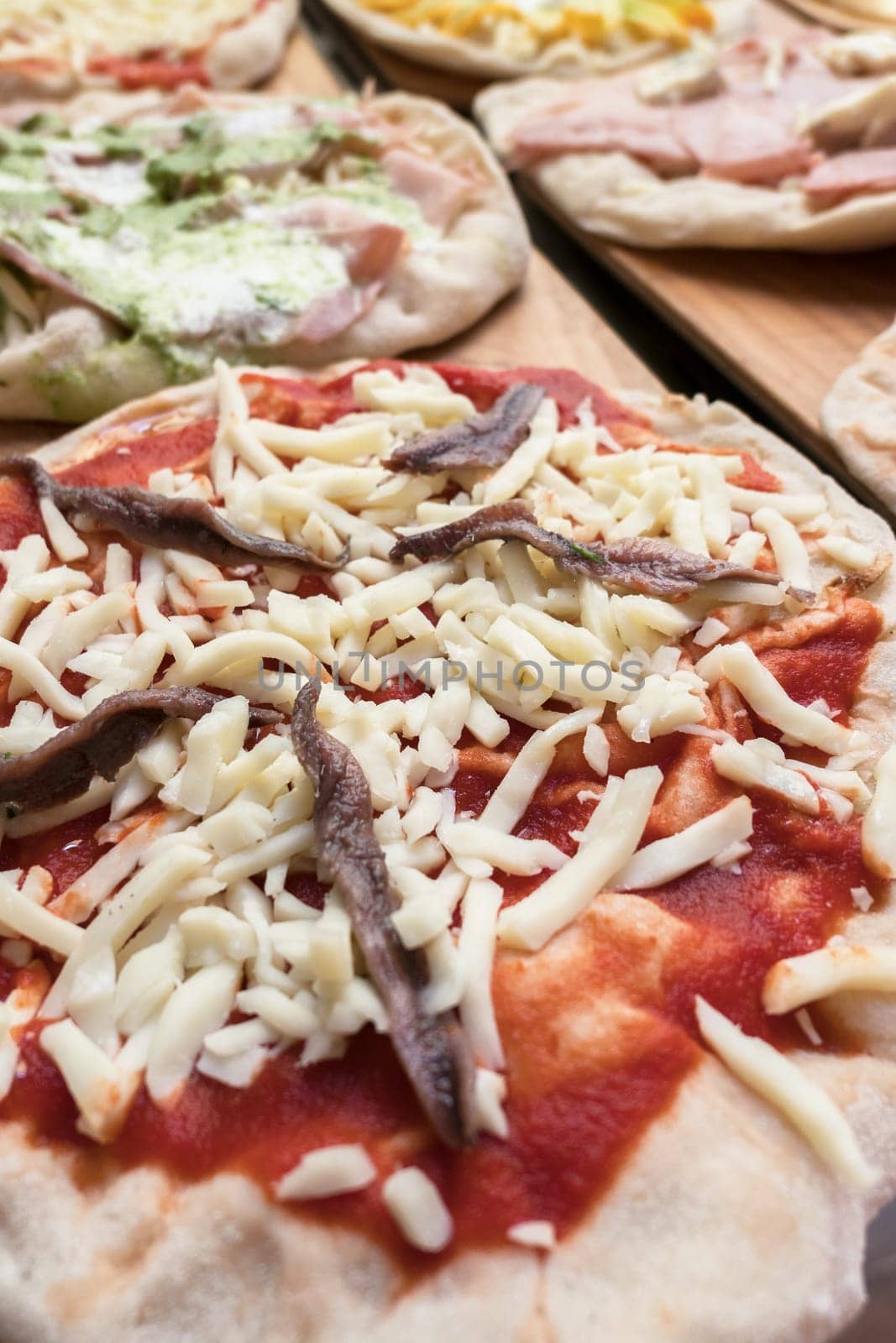 Variety of raw pizzas to bake. Restaurant. Pizzeria. Italian food.