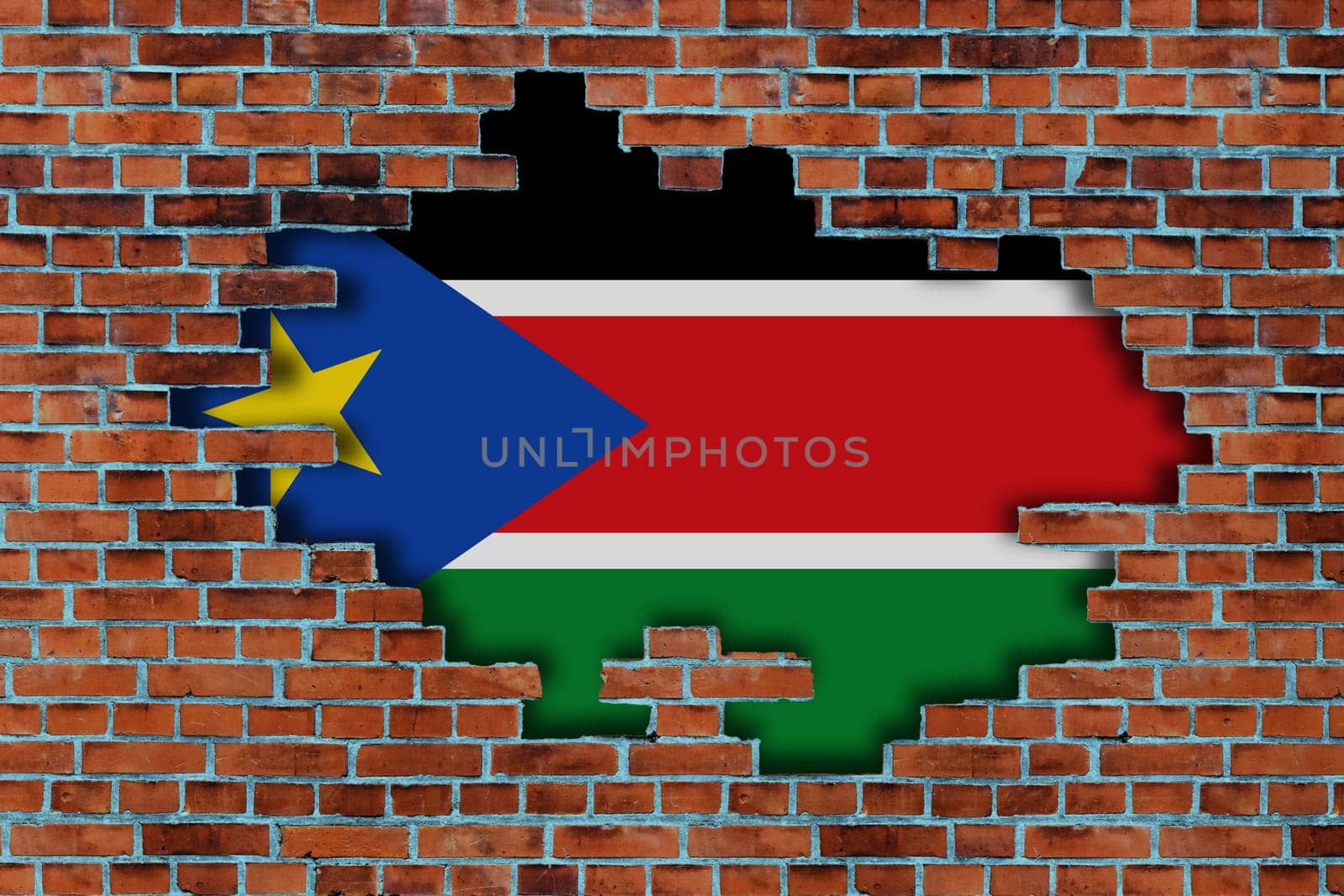3D Flag of South Sudan behind the broken old stone wall background.