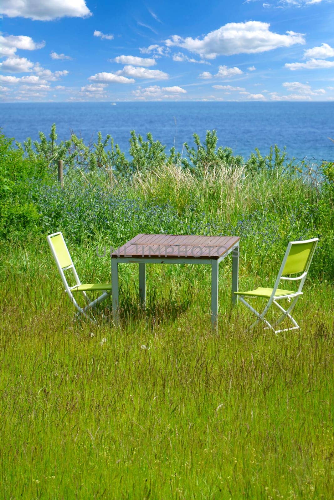 Garden furniture on green lawn with views of the Baltic Sea