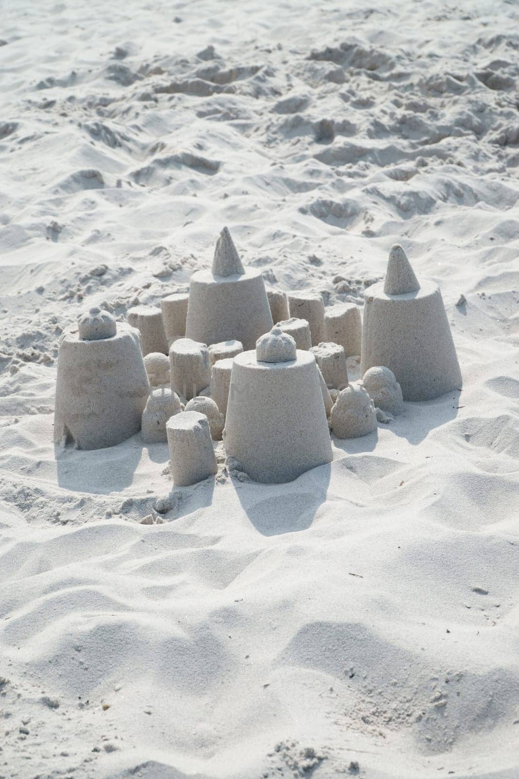 Small sand castle on the sandy beach