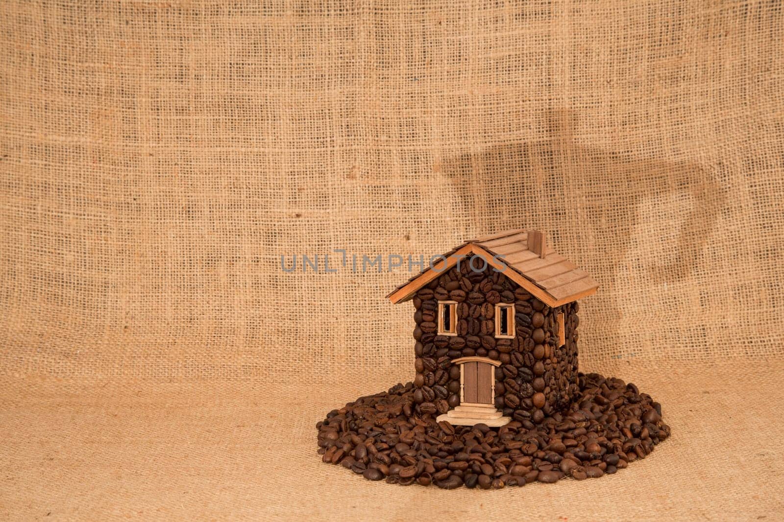 House made of coffee on juta background