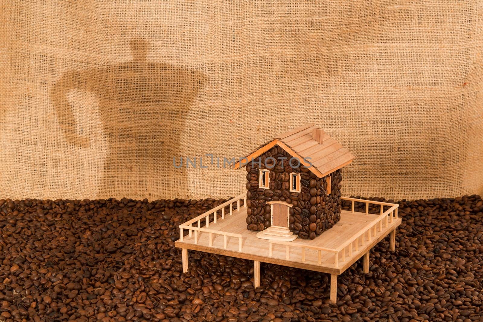 House made of coffee on juta background