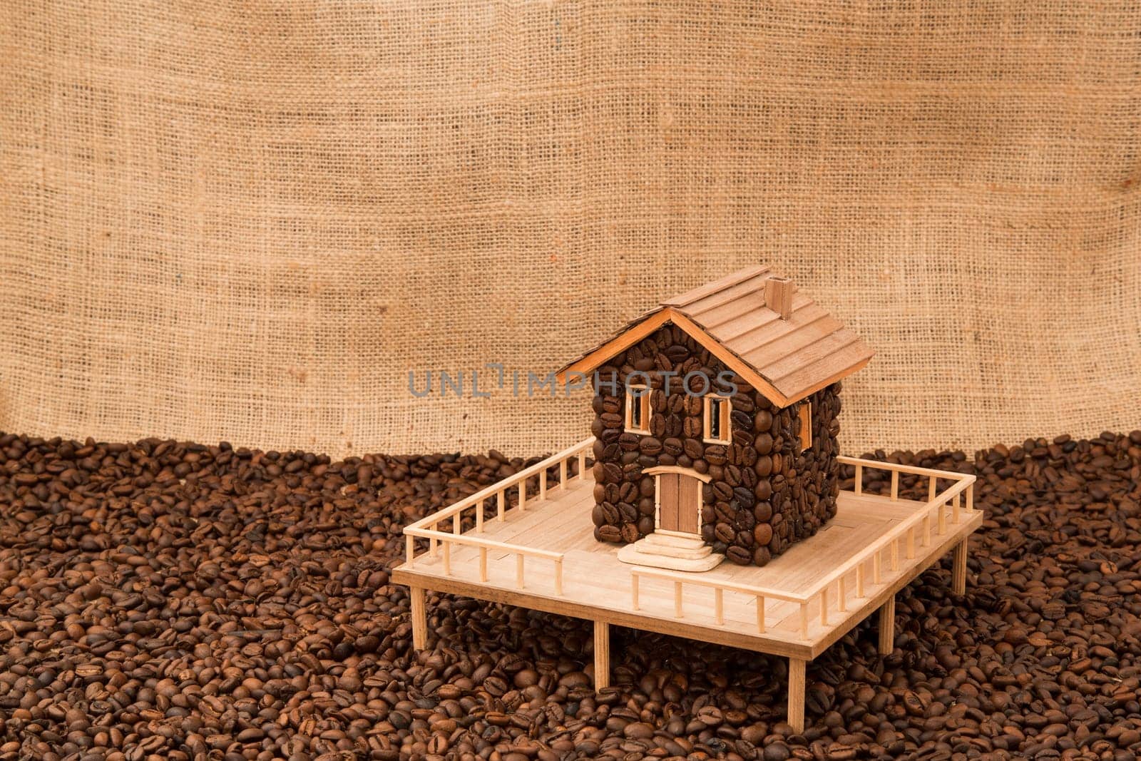 House made of coffee on juta background
